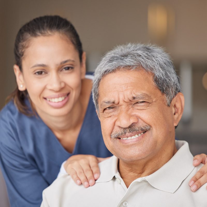 portrait-of-elderly-man-with-a-nurse-bonding-during-a-checkup-at-assisted-living-homecare-smile-.jpg